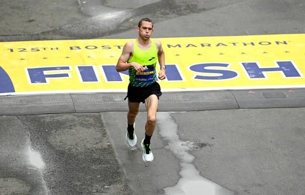 Albertson of the United States crosses the finish line during the 125th Boston Marathon on October 11, 2021 in Boston, Massachusetts.
