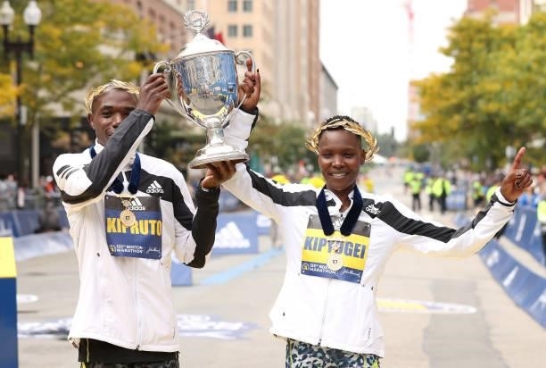Benson Kipruto and Diana Kipyogei of Kenya react after winning the men's and women's divisions of the 125th Boston Marathon on October 11, 2021 in...