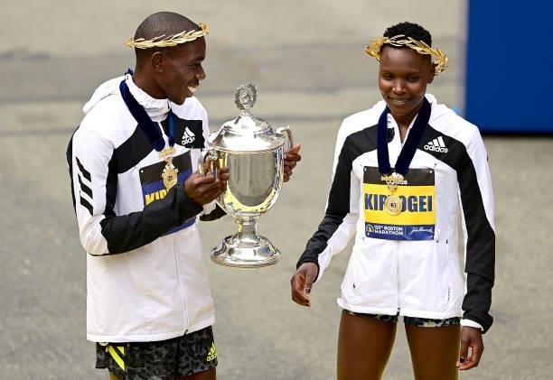 Benson Kipruto and Diana Kipyogei of Kenya react after winning the men's and women's races of the 125th Boston Marathon on October 11, 2021 in...