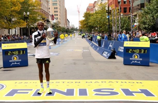 Benson Kipruto of Kenya poses with the Champion's Trophy after winning the 125th Boston Marathon on October 11, 2021 in Boston, Massachusetts.