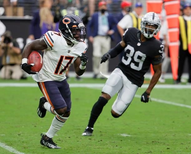 Wide receiver Jakeem Grant Sr. #17 of the Chicago Bears returns a punt against cornerback Nate Hobbs of the Las Vegas Raiders during their game at...