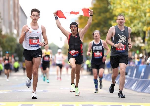 Runners near the finish line during the 125th Boston Marathon on October 11, 2021 in Boston, Massachusetts.