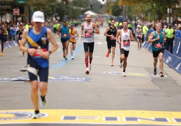 Runners near the finish line during the 125th Boston Marathon on October 11, 2021 in Boston, Massachusetts.