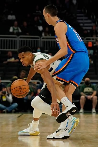 Giannis Antetokounmpo of the Milwaukee Bucks steals the ball from Aleksej Pokusevski of the Oklahoma City Thunder in the first half during a...