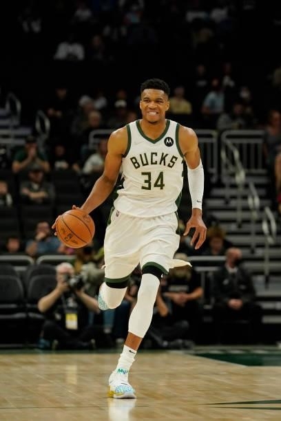 Giannis Antetokounmpo of the Milwaukee Bucks dribbles the ball against the Oklahoma City Thunder in the first half during a preseason game at Fiserv...