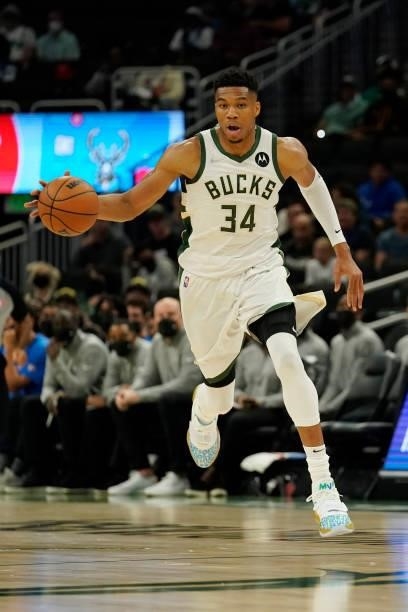 Giannis Antetokounmpo of the Milwaukee Bucks dribbles the ball against the Oklahoma City Thunder in the first half during a preseason game at Fiserv...