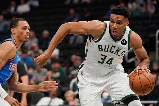 Giannis Antetokounmpo of the Milwaukee Bucks drives to the basket against Darius Bazley of the Oklahoma City Thunder in the first half during a...