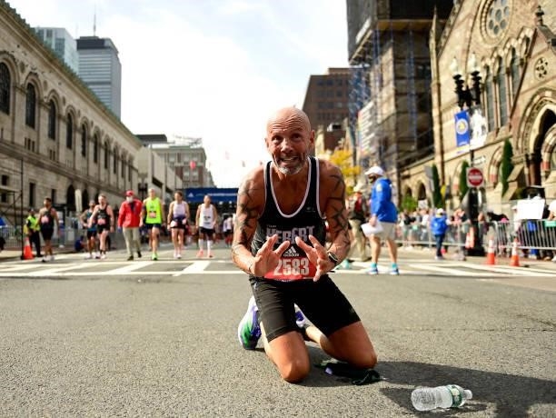 Karl Hebert of Canada reacts after crossing the finish line during the 125th Boston Marathon on October 11, 2021 in Boston, Massachusetts.
