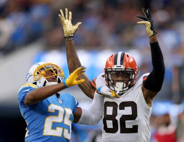 Rashard Higgins of the Cleveland Browns and Chris Harris of the Los Angeles Chargers react to a pass during a 47-42 Chargers win at SoFi Stadium on...