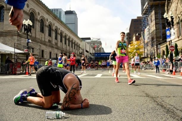 Karl Hebert of Canada reacts after crossing the finish line during the 125th Boston Marathon on October 11, 2021 in Boston, Massachusetts.