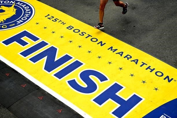 Runner crosses the finish line during the 125th Boston Marathon on October 11, 2021 in Boston, Massachusetts.