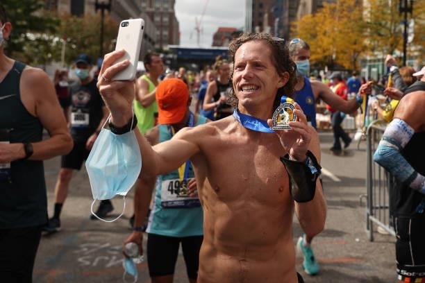 Runner takes a selfie with his medal after the 125th Boston Marathon on October 11, 2021 in Boston, Massachusetts.