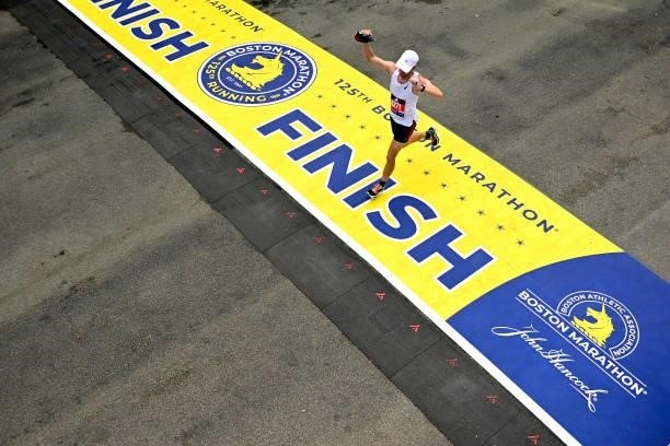 Aaron Harris reacts as he crosses the finish line during the 125th Boston Marathon on October 11, 2021 in Boston, Massachusetts.