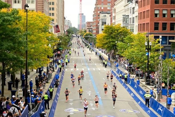 Runners near the finish line on Boylston Street during the 125th Boston Marathon on October 11, 2021 in Boston, Massachusetts.