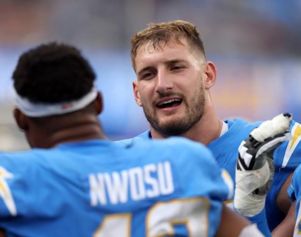 Joey Bosa of the Los Angeles Chargers and Uchenna Nwosu talk on the sidelines during a 47-42 win over the Cleveland Browns at SoFi Stadium on October...
