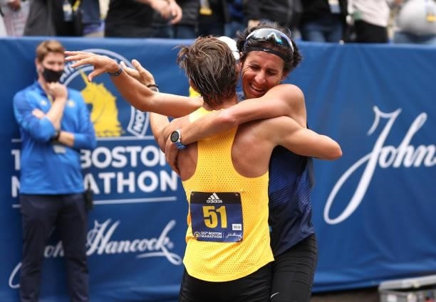 Blue Benadum and Luis Carlos Rivero react after crossing the finish line during the 125th Boston Marathon on October 11, 2021 in Boston,...