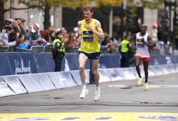 Jake Robertson of new Zealand crosses the finish line during the 125th Boston Marathon on October 11, 2021 in Boston, Massachusetts.