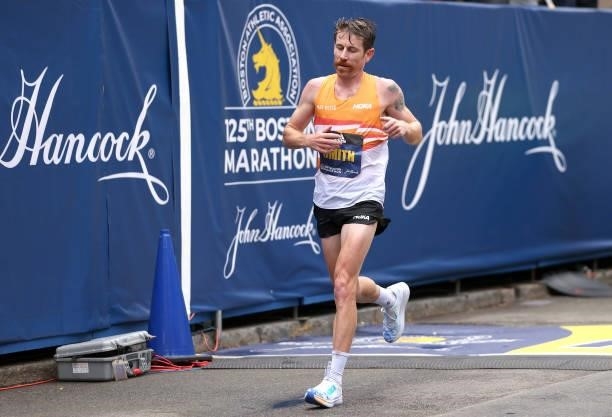 Scott Smith of the United States crosses the finish line during the 125th Boston Marathon on October 11, 2021 in Boston, Massachusetts.