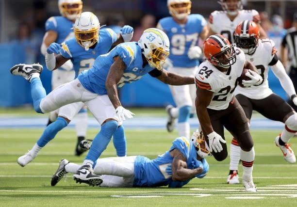 Nick Chubb of the Cleveland Browns runs as he is chased by Derwin James during a 49-42 loss to the Chargers at SoFi Stadium on October 10, 2021 in...