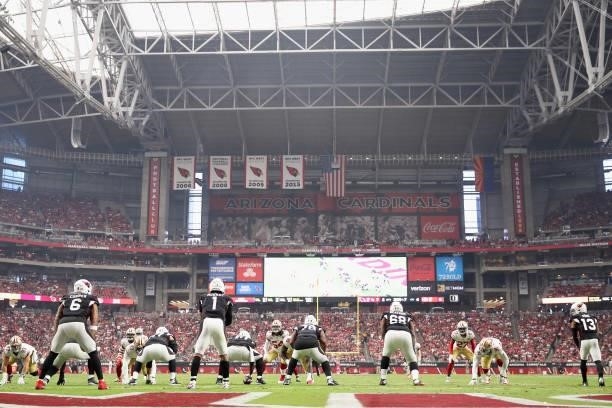 Quarterback Kyler Murray of the Arizona Cardinals prepares to snap the football during the NFL game at State Farm Stadium on October 10, 2021 in...