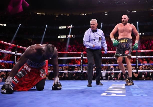 Tyson Fury knocks down Deontay Wilder in the third round during their WBC heavyweight championship at T-Mobile Arena on October 09, 2021 in Las...