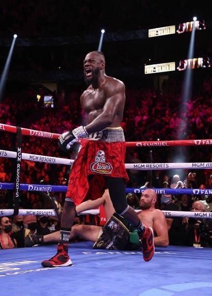 Deontay Wilder knocks down Tyson Fury for the first of two knockdowns in the fourth round during their WBC heavyweight championship at T-Mobile Arena...