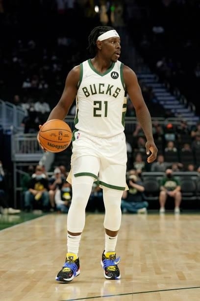 Jrue Holiday of the Milwaukee Bucks dribbles the ball against the Oklahoma City Thunder in the first half during a preseason game at Fiserv Forum on...