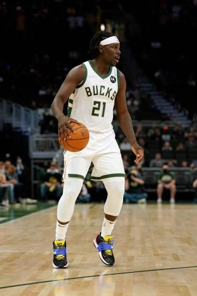 Jrue Holiday of the Milwaukee Bucks dribbles the ball against the Oklahoma City Thunder in the first half during a preseason game at Fiserv Forum on...