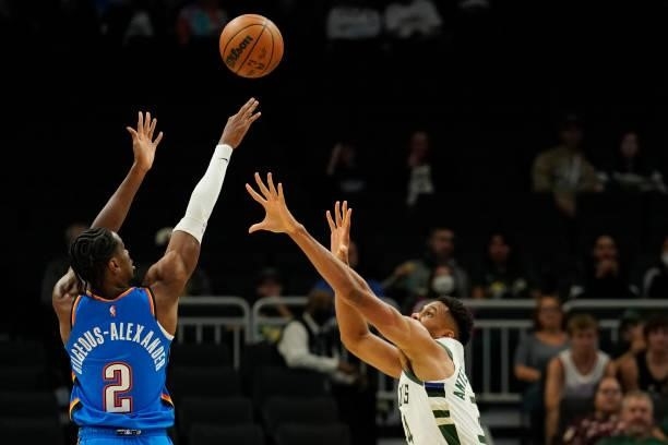 Shai Gilgeous-Alexander of the Oklahoma City Thunder shoots the ball against Giannis Antetokounmpo of the Milwaukee Bucks in the first half during a...