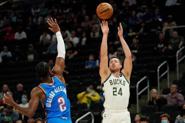 Pat Connaughton of the Milwaukee Bucks shoots the ball against Shai Gilgeous-Alexander of the Oklahoma City Thunder in the first half during a...