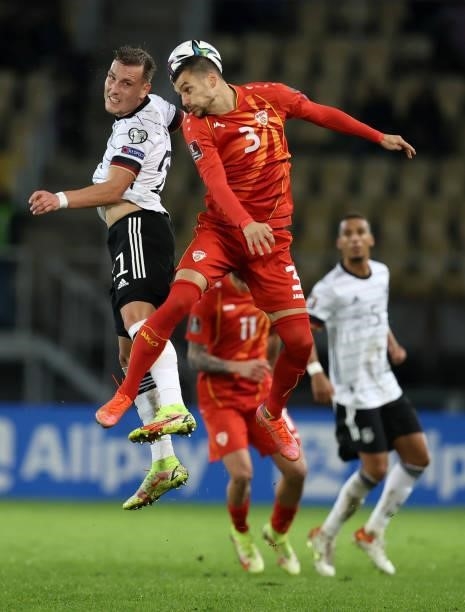 David Raum of Germany and Stefan Askovski of North Macedonia battle for the ball during the 2022 FIFA World Cup Qualifier match between North...