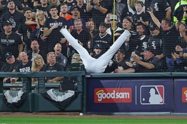 Jose Abreu of the Chicago White Sox falls trying to catch a foul ball during game three of the American League Division Series against the Houston...