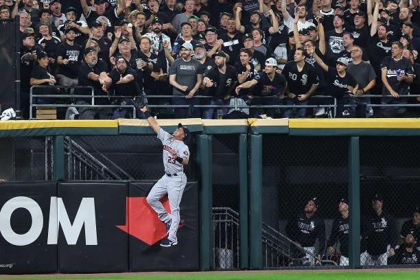 Michael Brantley of the Houston Astros is unable to catch a home run ball during game three of the American League Division Series against the...
