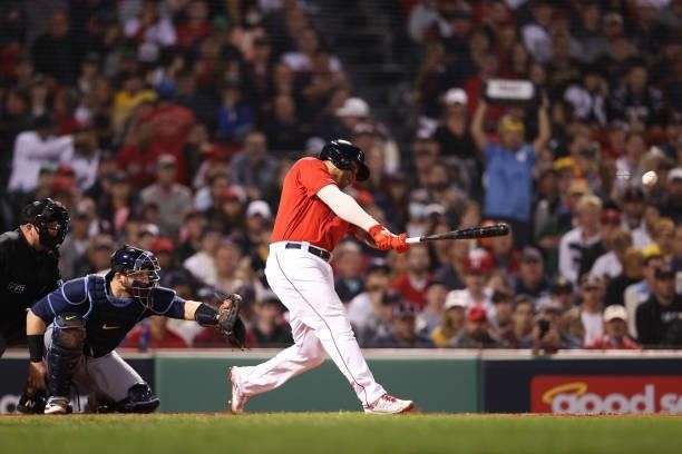 Rafael Devers of the Boston Red Sox hits a single in the first inning against the Tampa Bay Rays during Game 4 of the American League Division Series...