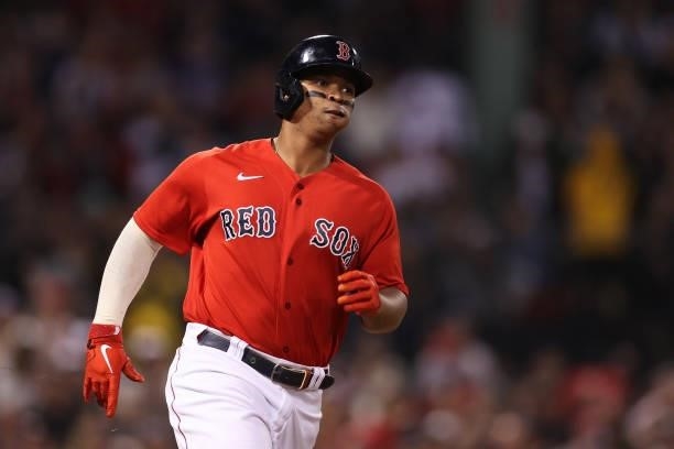 Rafael Devers of the Boston Red Sox runs to first base on his single in the first inning against the Tampa Bay Rays during Game 4 of the American...