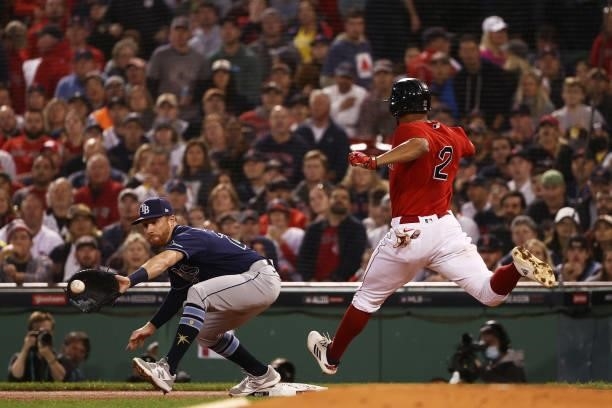 Xander Bogaerts of the Boston Red Sox is out at first by Jordan Luplow of the Tampa Bay Rays in the first inning during Game 4 of the American League...