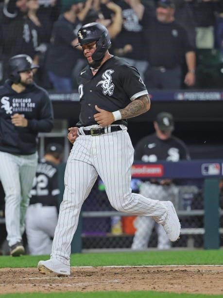 Yoan Moncada of the Chicago White Sox scores a run against the Houston Astros at Guaranteed Rate Field on October 10, 2021 in Chicago, Illinois. The...