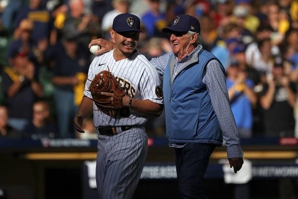 Keston Hiura of the Milwaukee Brewers speaks with Bob Uecker prior to game one of the National League Division Series against the Atlanta Braves at...