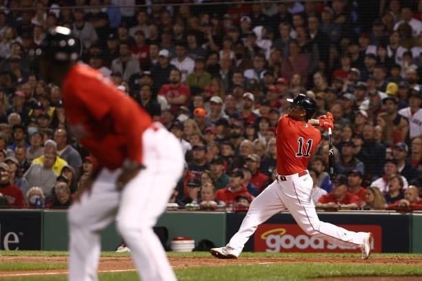 Rafael Devers of the Boston Red Sox hits a three-run homerun in the third inning against the Tampa Bay Rays during Game 4 of the American League...