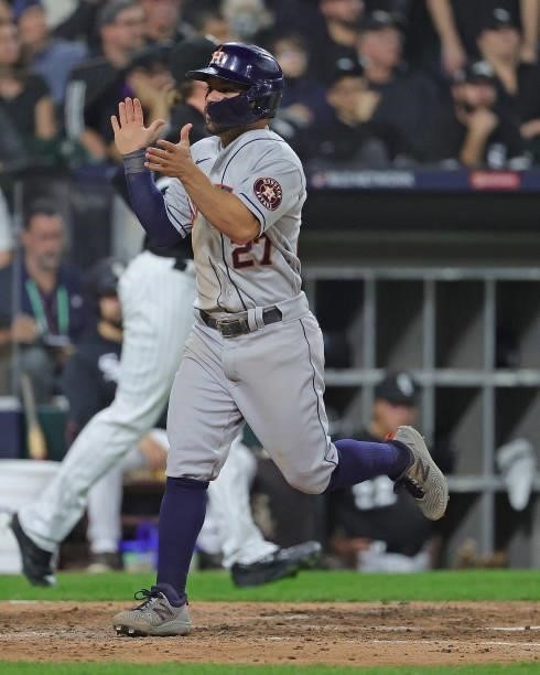 Jose Altuve of the Houston Astros celebrates as he scores a run against the Chicago White Sox at Guaranteed Rate Field on October 10, 2021 in...
