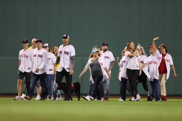 Former Boston Red Sox third baseman from the 2013 World Series Championship team Will Middlebrooks is accompanied by survivors of the Boston Marathon...