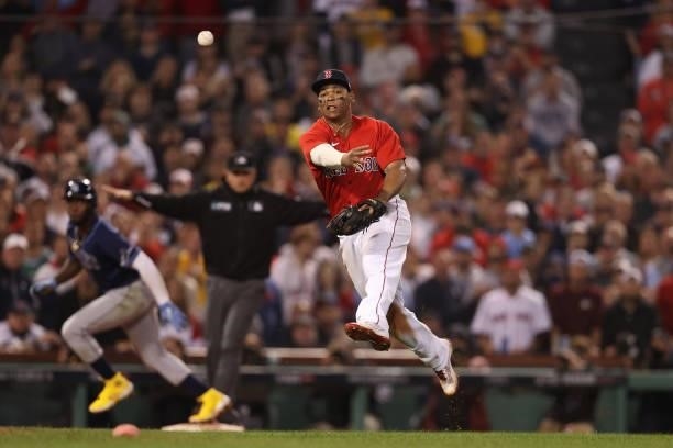 Rafael Devers of the Boston Red Sox throws to first to end the top of the eighth inning against the Tampa Bay Rays during Game 4 of the American...