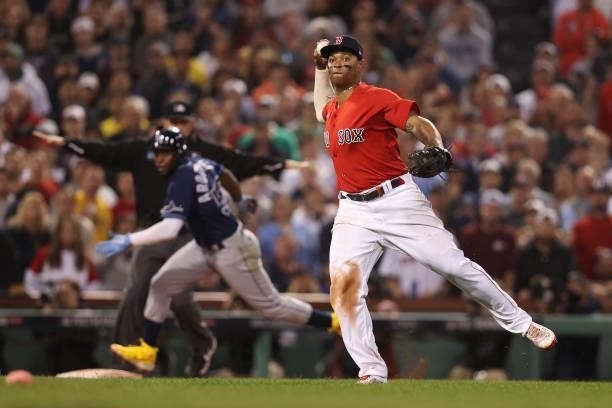 Rafael Devers of the Boston Red Sox throws to first to end the top of the eighth inning against the Tampa Bay Rays during Game 4 of the American...