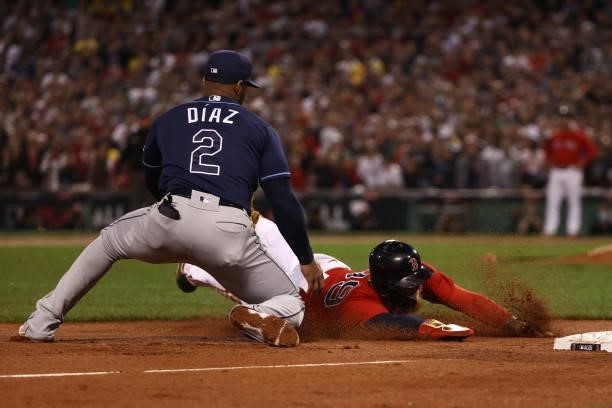 Alex Verdugo of the Boston Red Sox is tagged out by Yandy Diaz of the Tampa Bay Rays at third base in the eighth inning during Game 4 of the American...