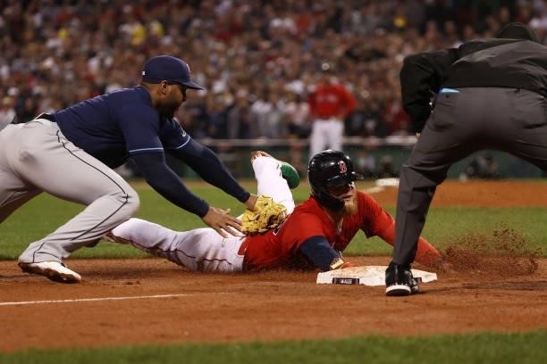 Alex Verdugo of the Boston Red Sox is tagged out by Yandy Diaz of the Tampa Bay Rays at third base in the eighth inning during Game 4 of the American...