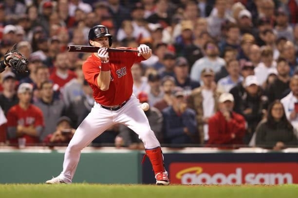Christian Arroyo of the Boston Red Sox bunts in the ninth inning against the Tampa Bay Rays during Game 4 of the American League Division Series at...
