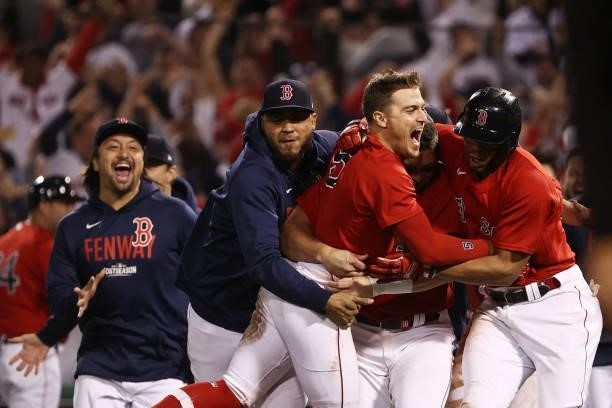 Enrique Hernandez of the Boston Red Sox celebrates his game winning sacrifice fly with teammates in the ninth inning against the Tampa Bay Rays...