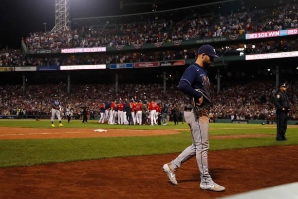 Kevin Kiermaier of the Tampa Bay Rays leaves the field as the Boston Red Sox celebrate their 6 to 5 victory during Game 4 of the American League...