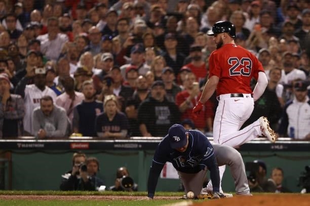 Travis Shaw of the Boston Red Sox is safe at first as Ji-Man Choi of the Tampa Bay Rays fails to catch the throw in the ninth inning during Game 4 of...