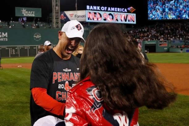 Alex Cora of the Boston Red Sox greets a family member as he celebrates their 6 to 5 win over the Tampa Bay Rays during Game 4 of the American League...